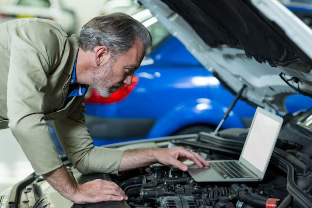 A man checks a car using a computer